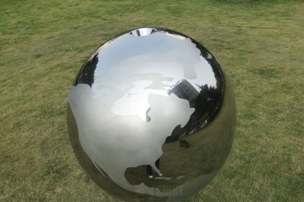 Steel sphere water fountain world map covered